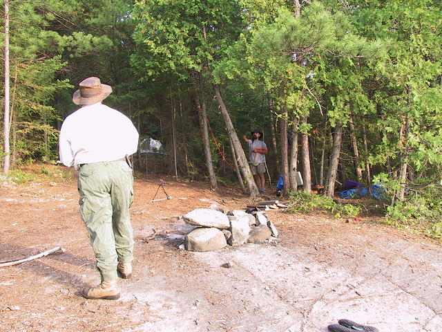 Gerald tying a rope to the tree as Pete watches from a safe distance.